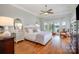Bright and airy bedroom boasts a lake view, hardwood floors, and a cozy sitting area at 17719 Springwinds Dr, Cornelius, NC 28031