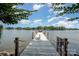 Private pier with a white chair overlooking the tranquil lake, perfect for relaxing at 17719 Springwinds Dr, Cornelius, NC 28031