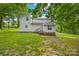 View of the backyard with a white home and steps leading to the back door at 221 Reliance Rd, Kings Mountain, NC 28086