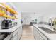 Well-lit kitchen showcasing stainless steel appliances, open wood shelves, and an eat-in kitchen island at 221 Reliance Rd, Kings Mountain, NC 28086