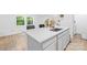 An open concept kitchen with a granite island, a stainless steel sink, and bright windows at 221 Reliance Rd, Kings Mountain, NC 28086