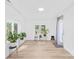 Bright living room with wood floors, white walls and ceiling, plants near windows, and recessed lighting at 221 Reliance Rd, Kings Mountain, NC 28086