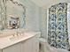 Bathroom featuring patterned wallpaper, modern vanity, and a stylish shower curtain at 2526 Sherwood Ave, Charlotte, NC 28207
