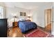 Cozy bedroom with hardwood floors, complemented by a vibrant rug and soft, ambient lighting for a warm and inviting space at 2526 Sherwood Ave, Charlotte, NC 28207