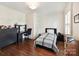 Neutral bedroom featuring a desk, dark wood floors, and a comfortable bed, perfect for relaxation and productivity at 2526 Sherwood Ave, Charlotte, NC 28207