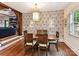 Charming dining room with decorative wallpaper, natural light, and wooden floors at 2526 Sherwood Ave, Charlotte, NC 28207