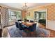 Bright dining room with patterned wallpaper, hardwood floors, and a view of the yard at 2526 Sherwood Ave, Charlotte, NC 28207