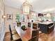 Bright dining room adjacent to kitchen with large windows and stylish lighting at 2526 Sherwood Ave, Charlotte, NC 28207