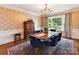 Formal dining room with elegant chandelier, patterned wallpaper, and large window at 2526 Sherwood Ave, Charlotte, NC 28207
