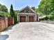 Detached garage with 2 doors, gray siding, and ample parking and patio space at 2526 Sherwood Ave, Charlotte, NC 28207