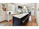 Spacious kitchen with white cabinets, a large center island with seating, and modern appliances at 2526 Sherwood Ave, Charlotte, NC 28207