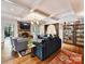 Comfortable living room with a stone fireplace, coffered ceilings, and hardwood floors at 2526 Sherwood Ave, Charlotte, NC 28207
