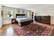 Spacious main bedroom with wood floors, large windows, a walk-in closet, and stylish furnishings at 2526 Sherwood Ave, Charlotte, NC 28207