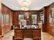 Wood-paneled office featuring custom cabinetry, hardwood floors, and natural light at 2526 Sherwood Ave, Charlotte, NC 28207
