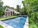 Backyard oasis featuring a pool and hot tub surrounded by lush greenery and lounge seating at 2526 Sherwood Ave, Charlotte, NC 28207