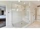 Glass-enclosed shower with tiled walls and a built-in seat at 2526 Sherwood Ave, Charlotte, NC 28207