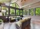 Spacious sunroom with wood ceiling, multiple windows, and stylish wicker furniture at 2526 Sherwood Ave, Charlotte, NC 28207