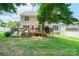 Backyard with deck, seating, string lights and a well-maintained lawn, perfect for outdoor enjoyment at 2908 Barnard Castle Ln, Matthews, NC 28104