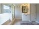 Bathroom with glass-enclosed shower, tub, and vanity with ample storage space at 2908 Barnard Castle Ln, Matthews, NC 28104
