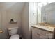 Charming half bathroom with vanity, marble countertop, and decorative fixtures at 2908 Barnard Castle Ln, Matthews, NC 28104