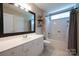 Bathroom vanity with a large mirror, storage cabinets and tiled floors at 2908 Barnard Castle Ln, Matthews, NC 28104