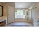 Spacious bathroom featuring a tiled tub, glass-enclosed shower, and vanity at 2908 Barnard Castle Ln, Matthews, NC 28104