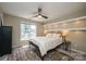 Cozy bedroom featuring a ceiling fan, window, and built-in shelves with warm lighting at 2908 Barnard Castle Ln, Matthews, NC 28104