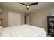 A well-lit bedroom with a neutral color palette featuring a ceiling fan and closet at 2908 Barnard Castle Ln, Matthews, NC 28104