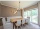 Bright dining room features a rectangular table with seating for six, complemented by natural light from a large window at 2908 Barnard Castle Ln, Matthews, NC 28104
