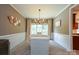 Elegant dining room with a large window, stylish chandelier, and seating for six, perfect for hosting gatherings at 2908 Barnard Castle Ln, Matthews, NC 28104