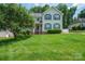 Charming two-story home with a well-manicured lawn and inviting front porch with blue shutters at 2908 Barnard Castle Ln, Matthews, NC 28104