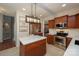 Efficient kitchen features dark wood cabinetry, stainless steel appliances, and a central island, maximizing space and functionality at 2908 Barnard Castle Ln, Matthews, NC 28104