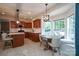 Open kitchen featuring wood cabinets, granite countertops, stainless steel appliances, and a sunlit breakfast nook at 2908 Barnard Castle Ln, Matthews, NC 28104