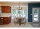 Bright kitchen nook with a round table surrounded by a bay window and a modern light fixture at 2908 Barnard Castle Ln, Matthews, NC 28104