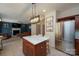 Spacious kitchen with dark wood cabinets, stainless steel appliances, and a marble-top island, seamlessly connecting to the living area at 2908 Barnard Castle Ln, Matthews, NC 28104