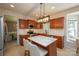 Well-appointed kitchen with dark wood cabinets, white countertops, and a functional island, creating a stylish cooking space at 2908 Barnard Castle Ln, Matthews, NC 28104