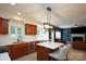 Open kitchen with dark wood cabinets, stainless steel appliances, and a central island, ideal for cooking and entertaining at 2908 Barnard Castle Ln, Matthews, NC 28104