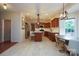 Bright, open-concept kitchen with tile floors, cherry cabinetry, granite countertops, and modern appliances at 2908 Barnard Castle Ln, Matthews, NC 28104