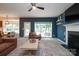 Spacious living room with fireplace, and access to back patio with backyard views at 2908 Barnard Castle Ln, Matthews, NC 28104
