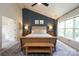 Main bedroom with dark accent wall, bedside lighting, and large area rug at 2908 Barnard Castle Ln, Matthews, NC 28104