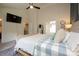 Bright main bedroom with en suite bath, ceiling fan, and television at 2908 Barnard Castle Ln, Matthews, NC 28104