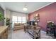 Bright office with large window, stylish desk, comfortable sofa, and decorative accents, creating a welcoming workspace at 2908 Barnard Castle Ln, Matthews, NC 28104