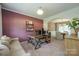 Inviting office with a wooden desk, comfortable sofa, and stylish decor for a productive workspace at 2908 Barnard Castle Ln, Matthews, NC 28104