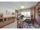 Well-lit office featuring a wooden desk, leather chair, and storage cabinet, offering a functional and attractive workspace at 2908 Barnard Castle Ln, Matthews, NC 28104