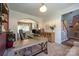 Cozy office with a wooden desk setup, shelving, and seamless transition to the adjacent dining and living areas at 2908 Barnard Castle Ln, Matthews, NC 28104
