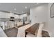 Dining area view with modern table, upholstered chairs, and an adjacent kitchen at 318 Willow Wood Ct, Matthews, NC 28104
