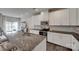 Bright kitchen with granite counters, white cabinets, stainless appliances and bar stool seating at 318 Willow Wood Ct, Matthews, NC 28104