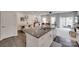 Modern kitchen island overlooking a living and dining area with lots of natural light at 318 Willow Wood Ct, Matthews, NC 28104