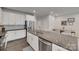 Bright kitchen featuring granite counters, white cabinetry, and stainless steel appliances at 318 Willow Wood Ct, Matthews, NC 28104