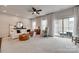 Open-concept living room with plush carpet, neutral tones, and ample natural light from sliding glass doors at 318 Willow Wood Ct, Matthews, NC 28104
